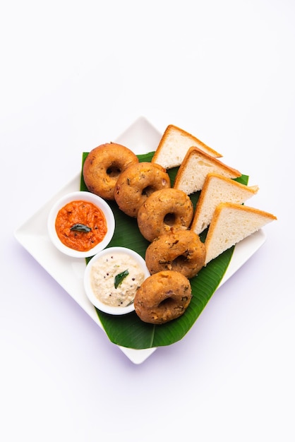 Instant leftover bread medu vada served with chutney and hot\
tea indian breakfast or snack recipe