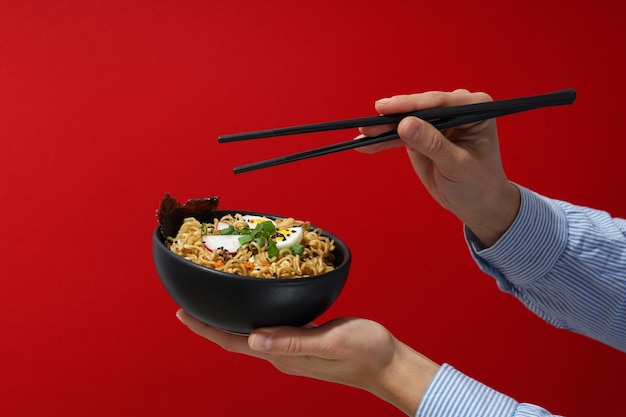 Instant noodles in a plate on a red background