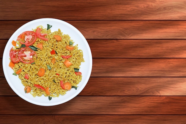 Instant noodles in white plate on wooden table background Top view