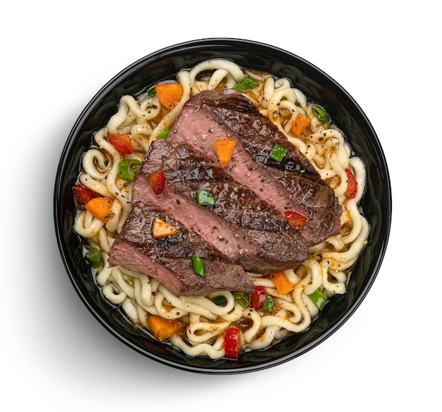 Instant noodles with grilled beef meat in black bowl top view