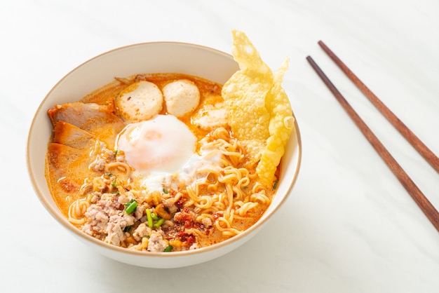 instant noodles with pork and meatballs in spicy soup or Tom Yum Noodles in Asian style