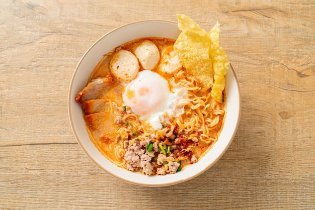 instant noodles with pork and meatballs in spicy soup or Tom Yum Noodles in Asian style