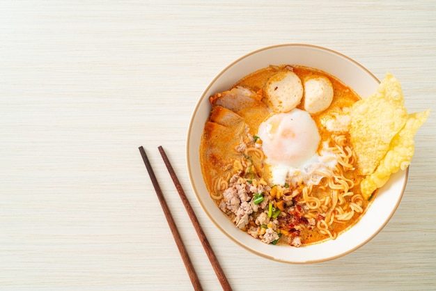 instant noodles with pork and meatballs in spicy soup or Tom Yum Noodles in Asian style