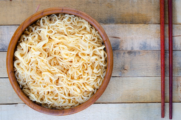 Instant noodles in wooden cup on wood background,Thai food style.