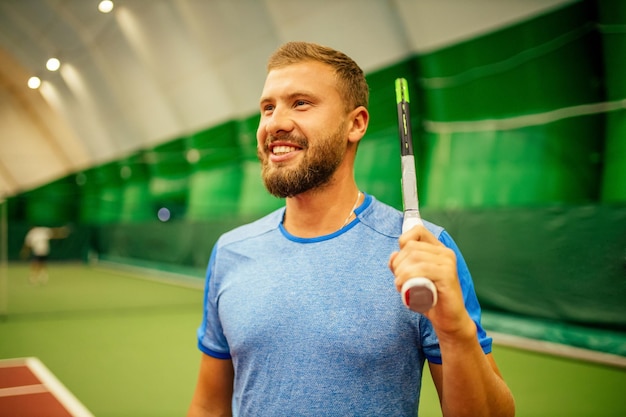 Instructeur of coach die leert tennissen op een indoorbaan