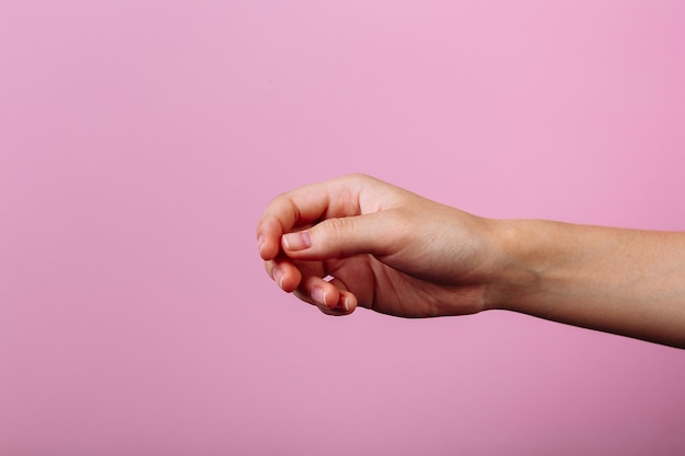 Instruction: how to eat with chopsticks. Isolated on pink background. step 1