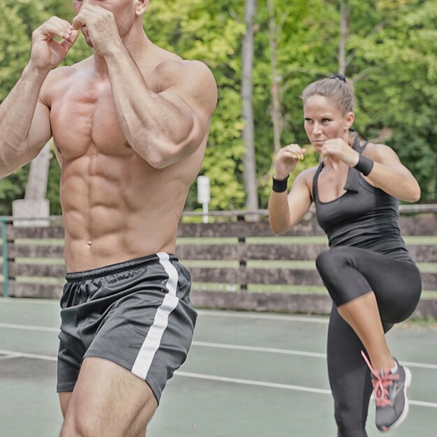 Instructor and female athlete on Tae Bo training