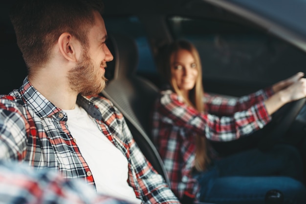 Instructor and female student smiling in vehicle