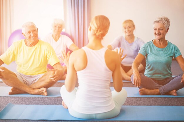 Instructor performing yoga with seniors