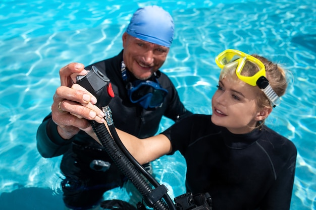 Instructor teaches woman to dive