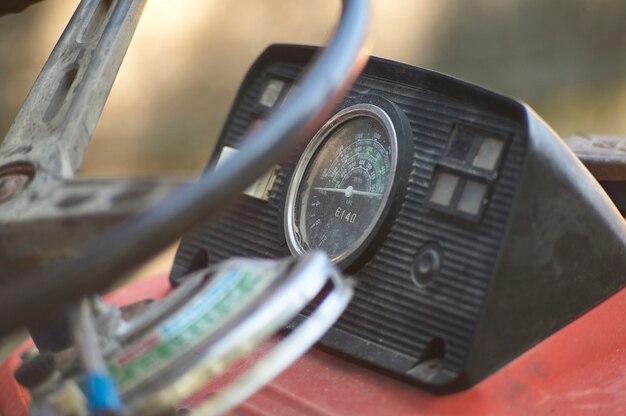 Instrument panel and speedometer of an old vintage tractor used for working on a farm.