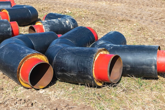 Insulated pipe Large metal pipes with a plastic sheath at a construction site Modern pipeline for supplying hot water and heating to a residential area