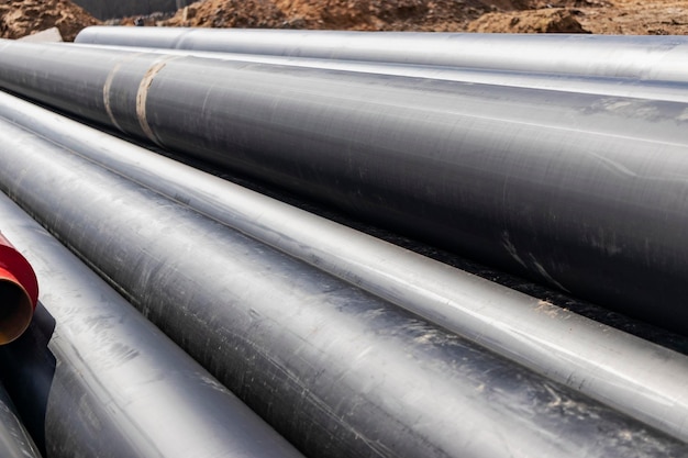 Insulated pipe Large metal pipes with a plastic sheath at a construction site Modern pipeline for supplying hot water and heating to a residential area