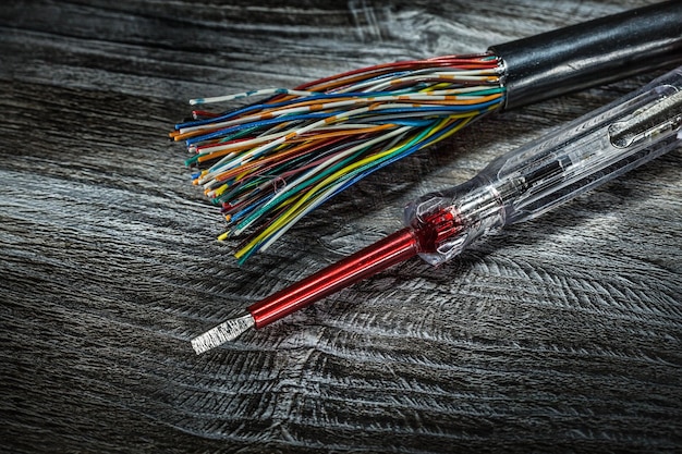 Insulated screwdriver electric wires on wooden board