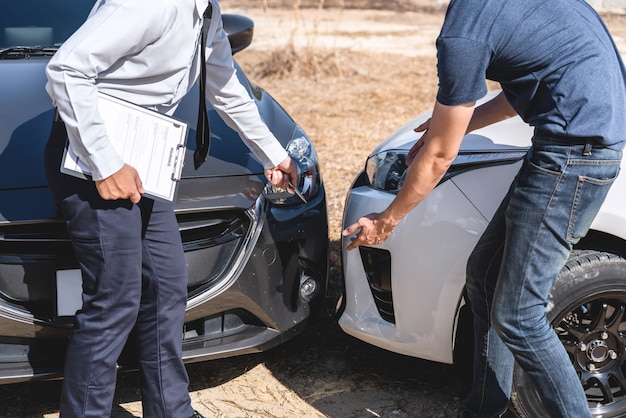 Photo insurance agent examining car crash
