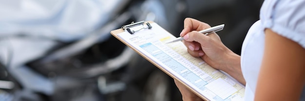 Photo insurance agent inspects damaged vehicle car insurance concept