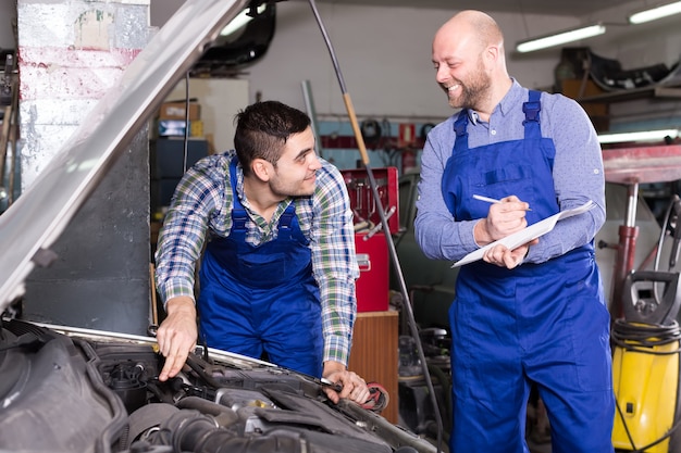 Insurance agent measuring car damage