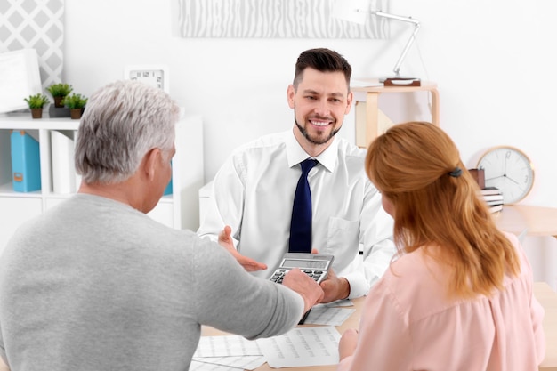 Insurance agent showing calculator with value of benefits