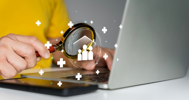 Insurance and assurance concept Person using magnifying glass focus to family insurance icons for medical