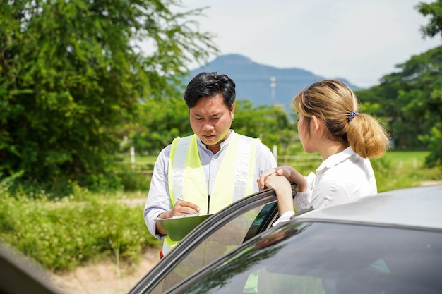 Insurance company officer ask the female driver about accident\
to write a report for customer claim