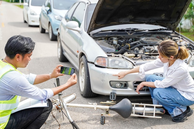 Insurance company officers are using mobile phones to take\
photos for customer insurance car claims