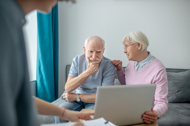 Insurance contract. Senior couple having an appointment with health insurance agent and discussing the contract details