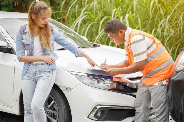 Insurance officers post a list of repairs on work list clipboard according sufferer woman point out