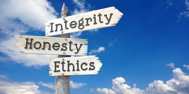 Integrity honesty ethics wooden signpost with three arrows