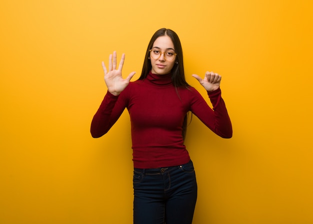 Intellectual young girl showing number six