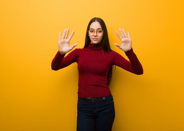 Intellectual young girl showing number ten