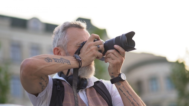 Intelligent Handsome With A Camera In Hand On A City Street On A Summer Evening.