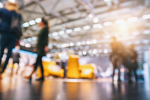 Intentionally blurred background crowd of people walking at a trade show