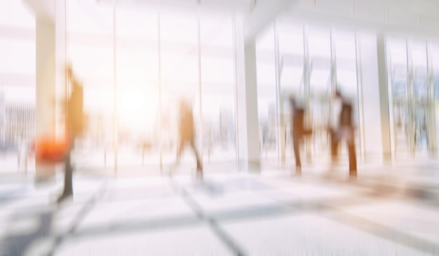 Intentionally blurred business people walking in a floor\
background