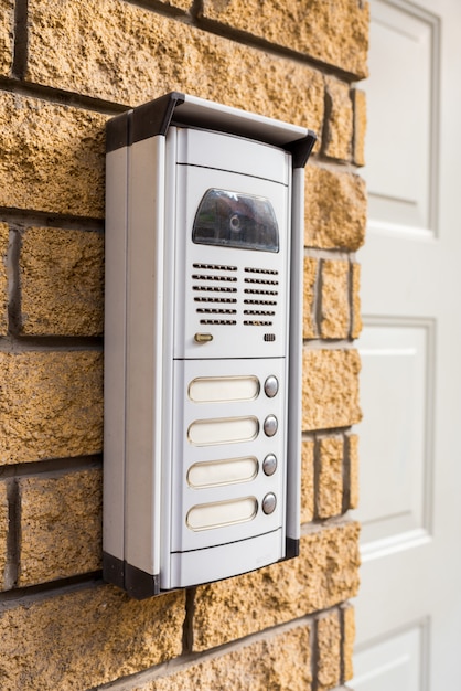 Intercom on a brick wall at the door