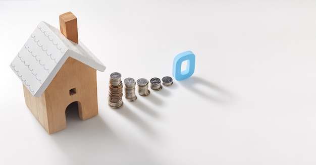 Interest with Home saving plans. House model and coins stack