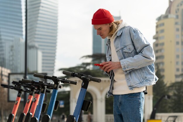 Interested scandinavian man explores scooter rental smartphone app for ecofriendly urban mobility