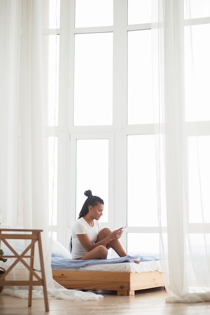 Interested woman spending leisure with smartphone