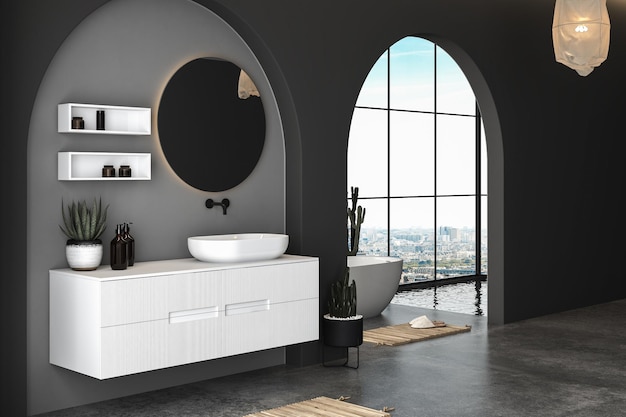 Interieur van moderne badkamer met betonnen en zwarte muren, betonnen vloer en witte wastafel.