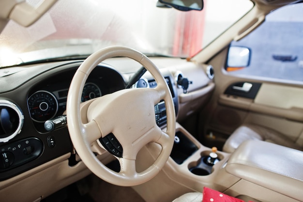 Interior of American SUV car on stand in workshop of service station