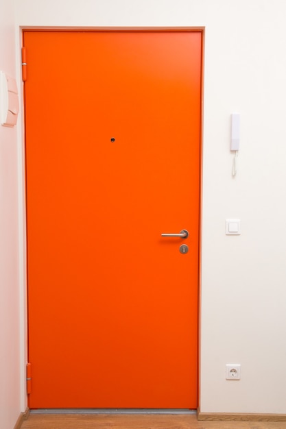 Interior apartment orange door over white wall