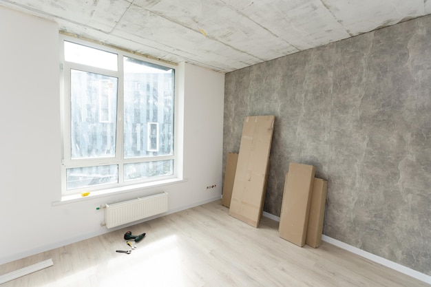 Interior of apartment with materials during on the renovation and construction, remodel wall from gypsum plasterboard or drywall