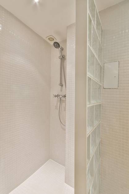 The interior of a bathroom in a cozy house with a toilet separated by a glass partition