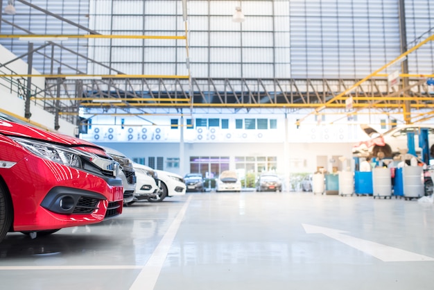 interior car-care center. The electric lift for cars in the service put on the epoxy floor in new car factory service