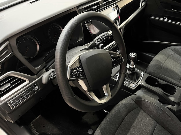 Interior of the car interior. Steering wheel, dashboard, computer screen, manual transmission