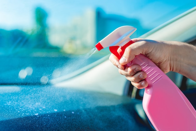 Interior car washing with cleanser sprayed from bottle