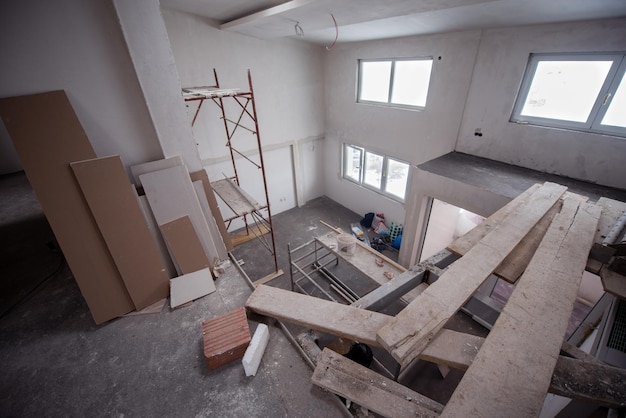 interior of construction site with scaffolding in a large modern unfinished duplex apartment