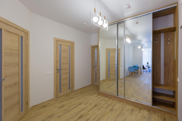 Interior of corridors in a large apartment with white walls