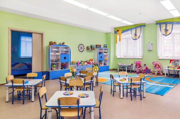 The interior of cozy blue room for classes and games in kindergarten.