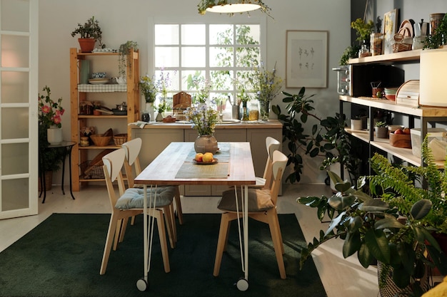 Interior of cozy kitchen in modern apartment with table and chairs on carpet