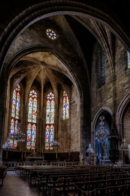 Interior, cross ribbed vault and stained glass of the gothic collegiate church of Capeatang